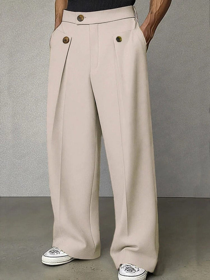Model wearing men's relaxed fit wide-leg pleated trousers. Versatile for stylish casual or professional looks.