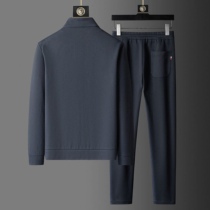 Close-up of men's zip-up track jacket, showcasing fabric & design for athletic style & everyday comfort.