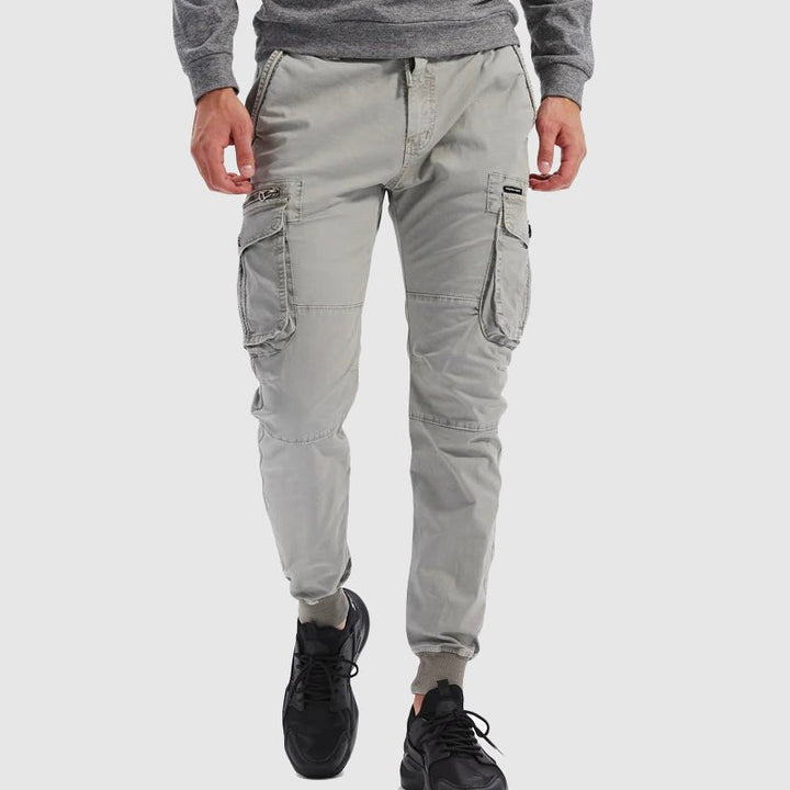 Comfortable men's activewear cargo joggers in gray, designed for movement, utility & everyday casual style.