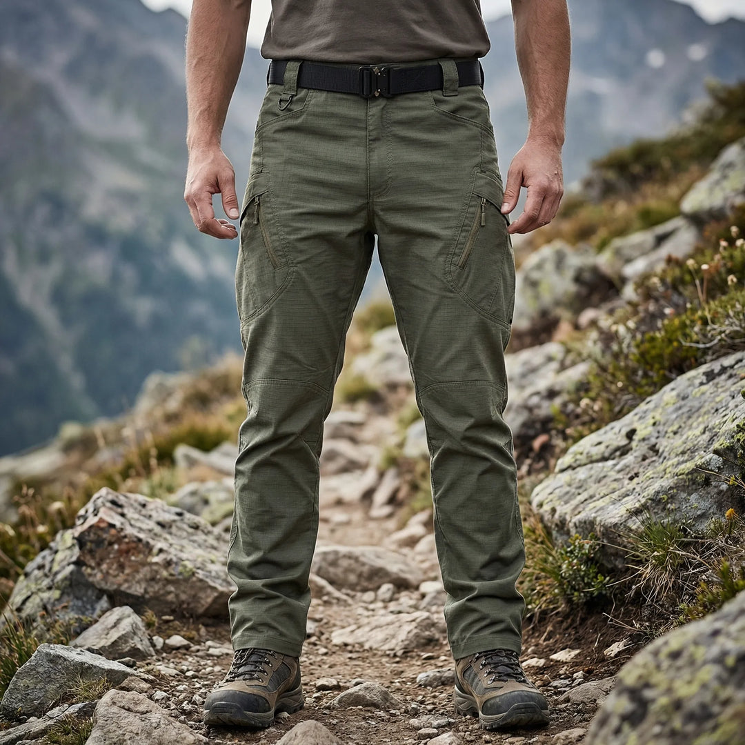Men's tactical cargo pants in olive green, featuring 9 utility pockets for outdoor adventures & workwear.