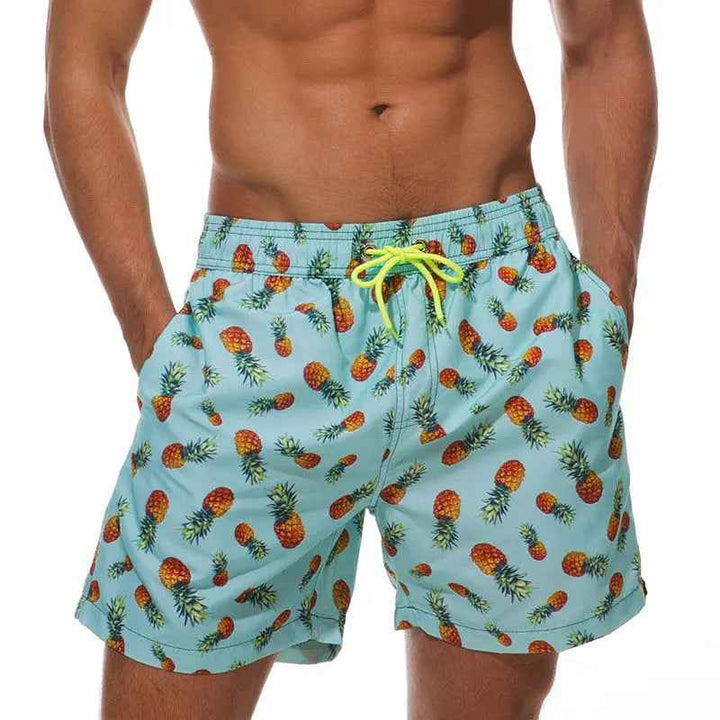 Men's tropical swim trunks with a vibrant pineapple print, perfect for beach and pool comfort.