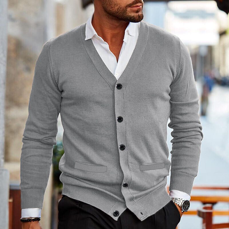 Handsome men's V-neck button cardigan styled over a shirt, perfect for a smart business casual or evening look.
