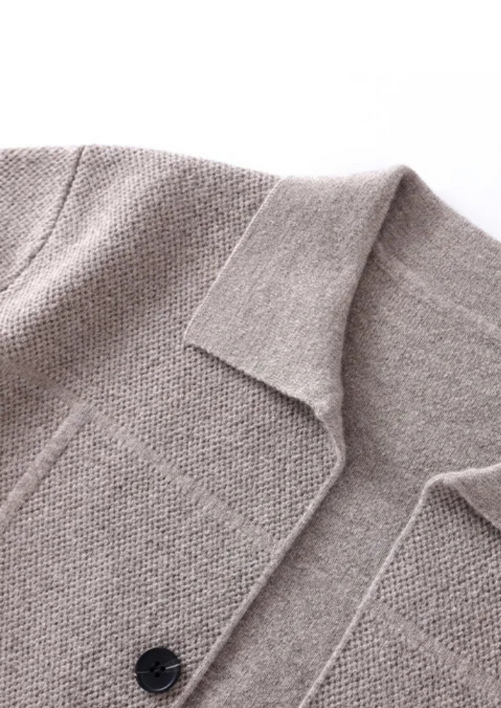 Stylish man wearing a button-up cardigan sweater over a shirt. Versatile men's knitwear for smart casual layering.