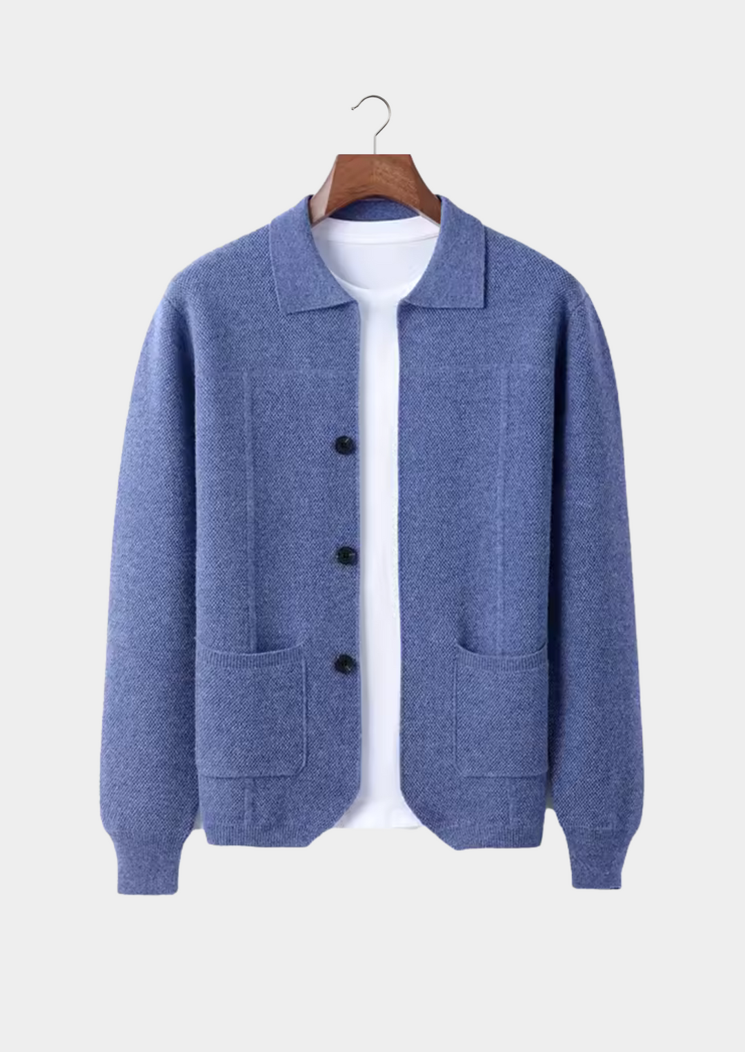 Detail of men's button-up cardigan with front pockets & classic buttons. Timeless knitwear piece for versatile style.