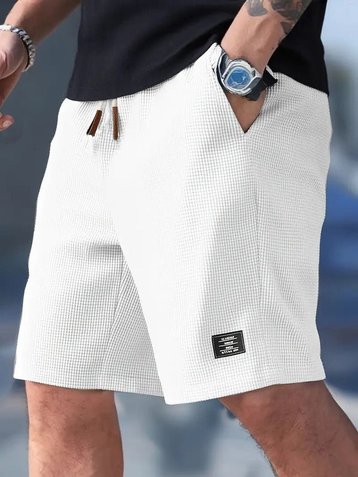 Versatile men's relaxed fit shorts. Waffle knit design ensures comfort for casual outings & loungewear.