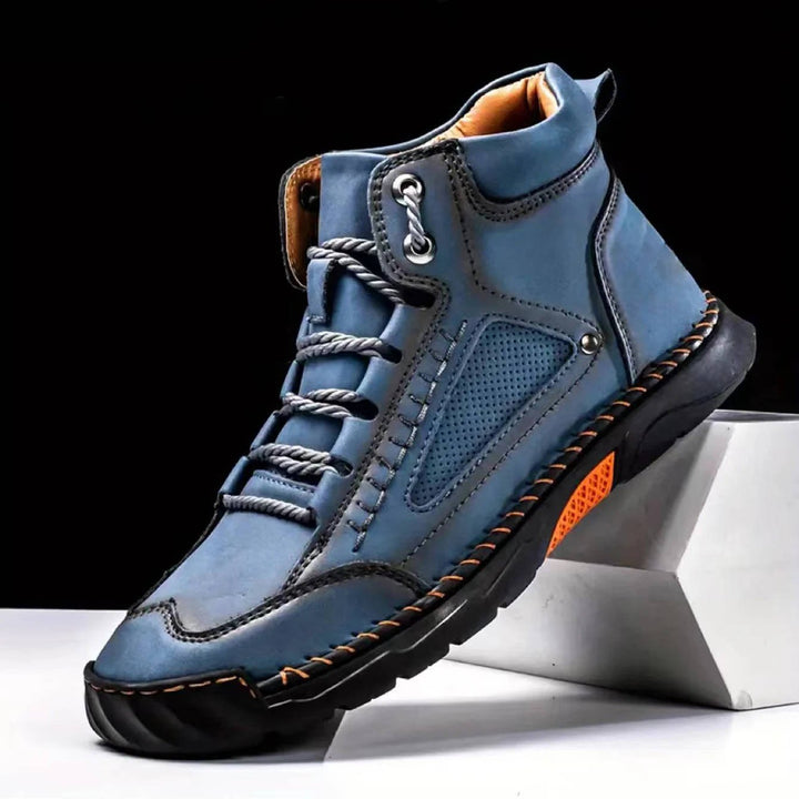 Close-up of men's waterproof hiking boot's sole, showing aggressive grip for varied terrain and safety.