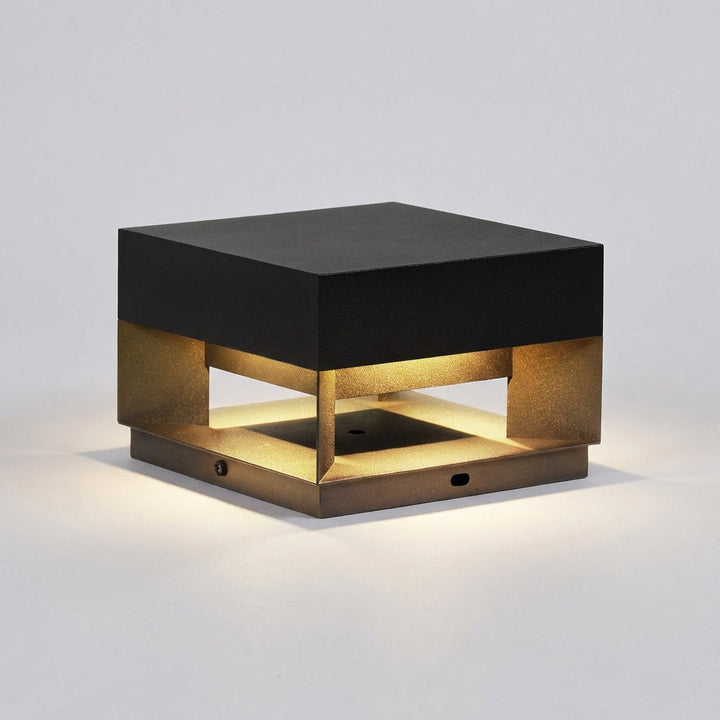 Sleek black minimalist square outdoor wall light, casting a warm glow on modern garden walls.