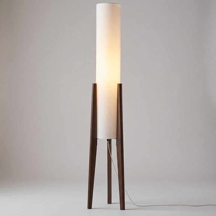 Scandinavian wood floor lamp, LED compatible, providing warm ambient light for a modern living room.