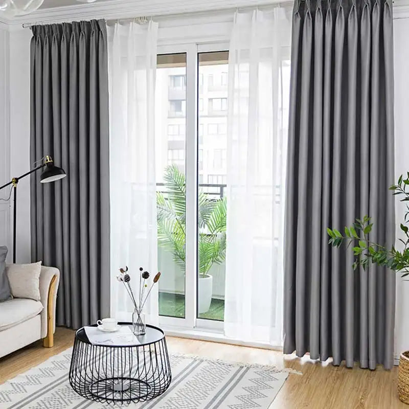 Close-up of modern black blackout curtain fabric, showing dense weave for thermal insulation and privacy