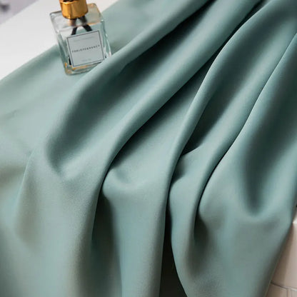 Detail of the black curtain's top hem, showcasing quality stitching and durable rod pocket design