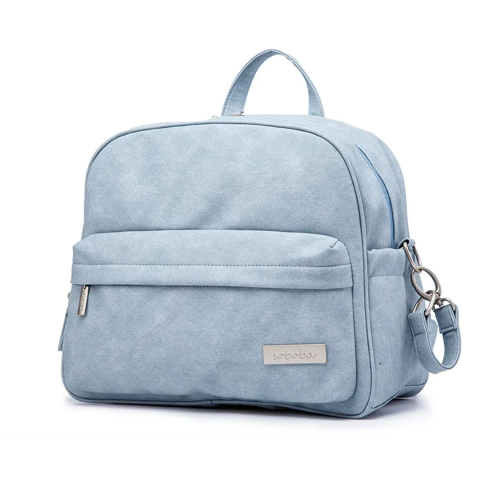 Details of modern diaper backpack's insulated bottle pocket, functional design, baby bag