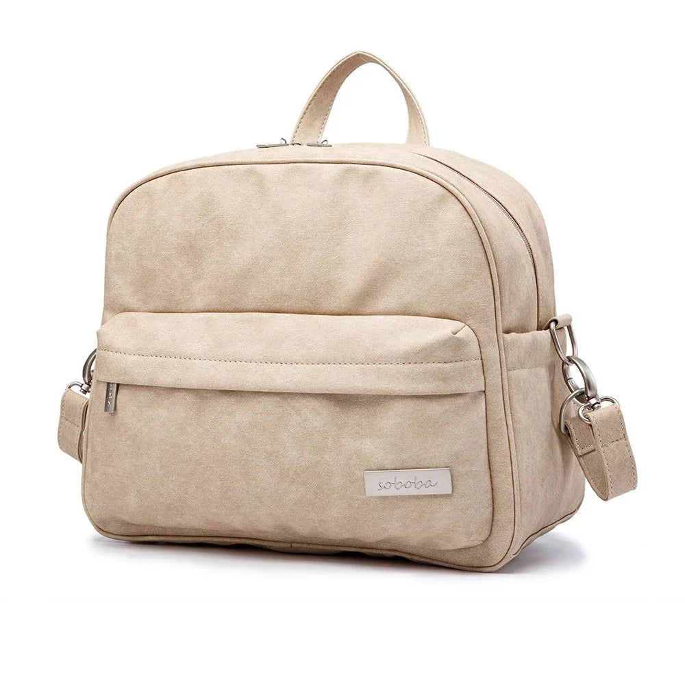 Side view of a sleek, modern PU leather diaper backpack with comfortable straps, baby gear