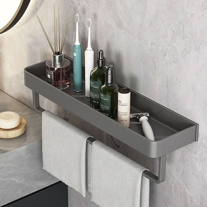 Sleek adhesive wall shelf with a built-in towel bar for space-saving bathroom storage.