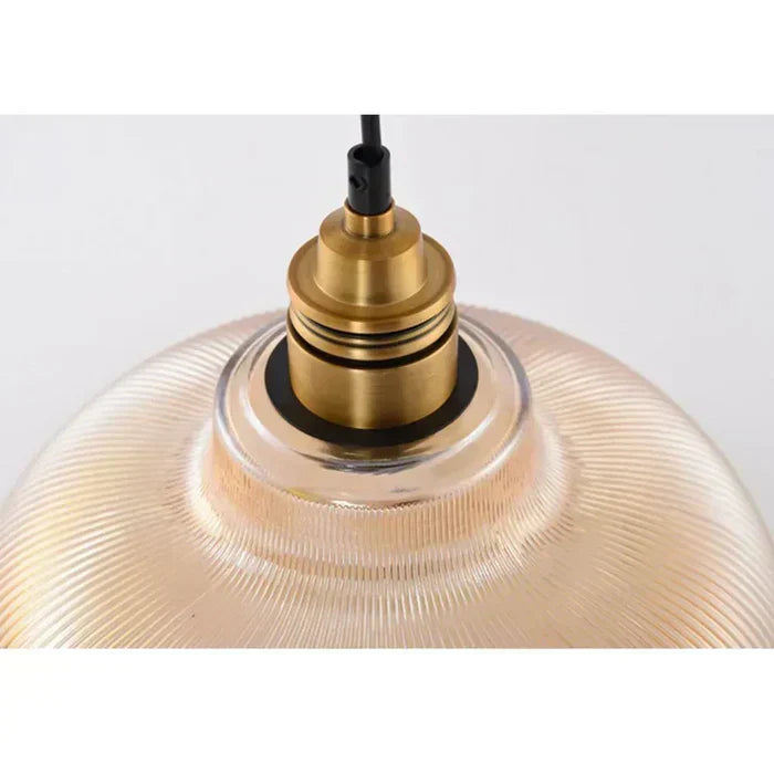 Suspended modern glass pendant light, elegant ceiling fixture enhancing interior design with ambient glow.