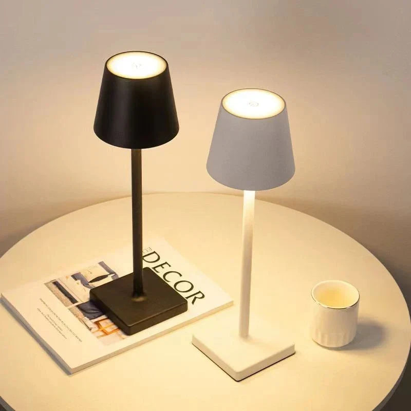 Modern portable LED table lamp, dimmable, rechargeable for indoor & outdoor use. Wireless home decor.