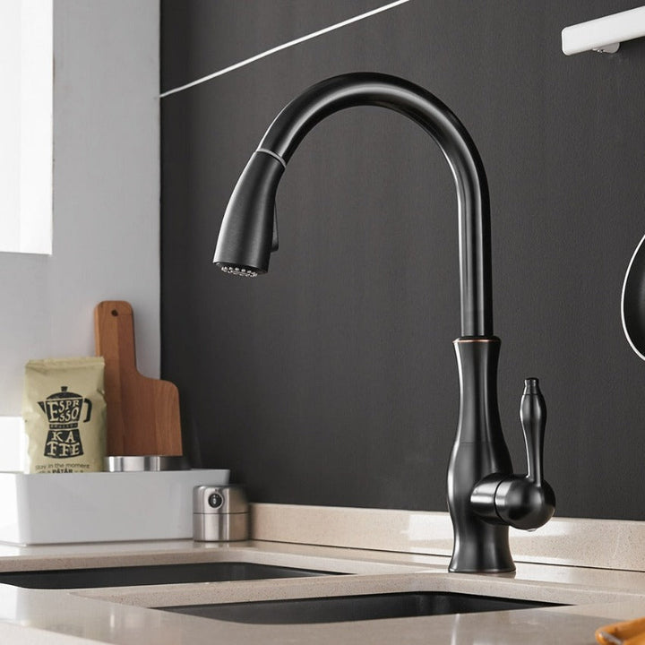 Elegant gold pull-out kitchen faucet, modern retractable design for a luxurious kitchen.