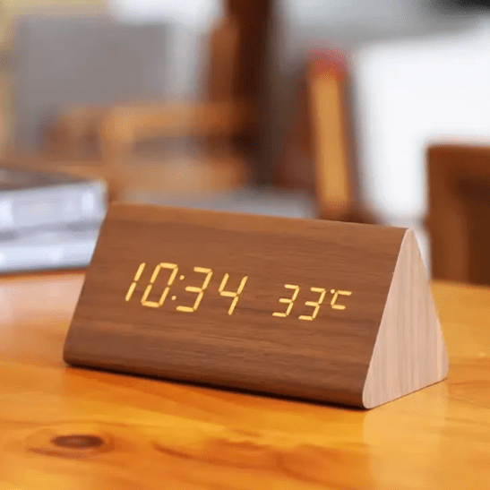 Modern voice-activated LED digital alarm clock with a sleek, minimalist display for home decor.