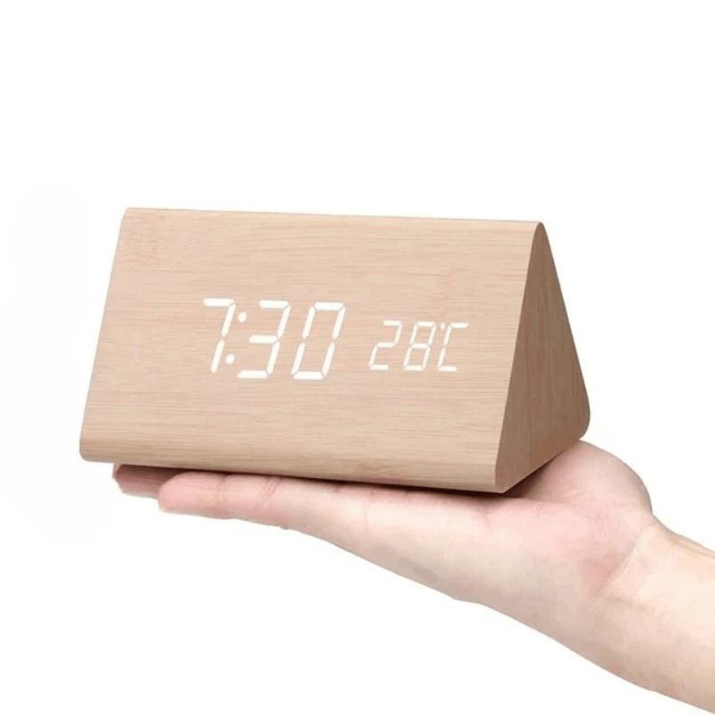 Voice-activated LED digital clock enhancing a modern aesthetic bedroom or office desk setting.