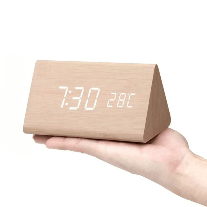Voice-activated LED digital clock enhancing a modern aesthetic bedroom or office desk setting.