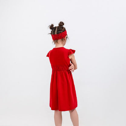 A woman wearing a stylish strapless red cotton dress, a chic look for summer and beachwear.