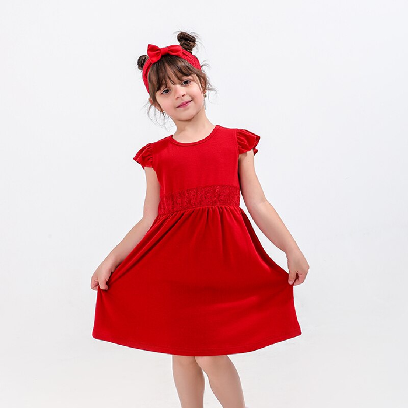 Side view of a mom and baby girl in adorable matching strapless red cotton dresses for summer.