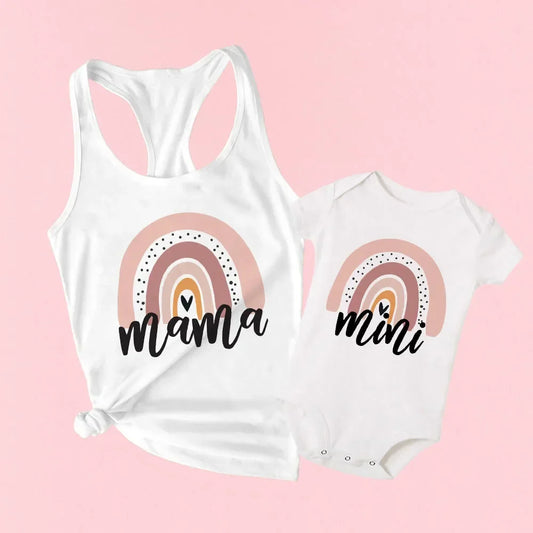 Mom and baby in matching rainbow outfits, pastel stripes, perfect for summer family photos.