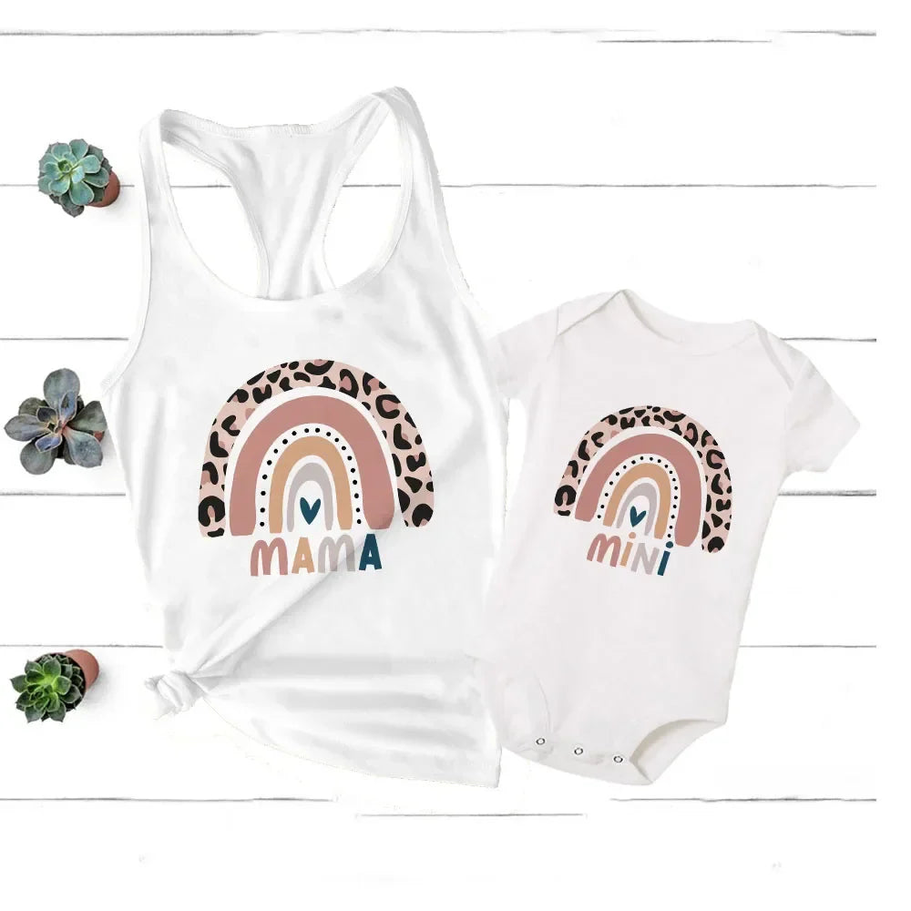 Family fashion: mother and child posing in bright rainbow themed summer clothes.