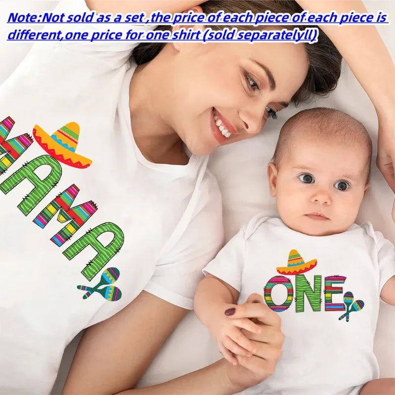Mom and baby smiling in their white 'ONE' first birthday matching outfits, polyester material