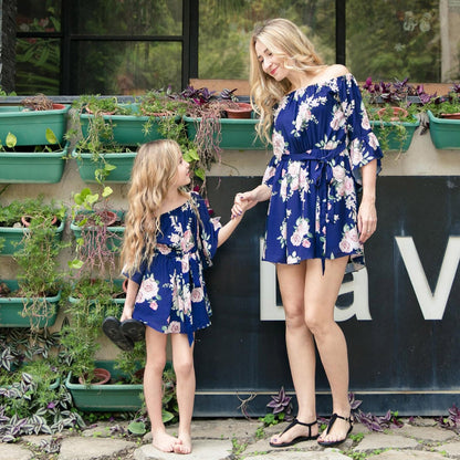 Matching floral summer dresses for women and girls, showcasing a vibrant blue pattern.