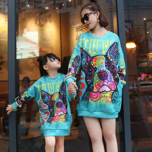 Mom and daughter in matching long-sleeve cotton dresses with cute dog print, perfect mommy and me outfits.
