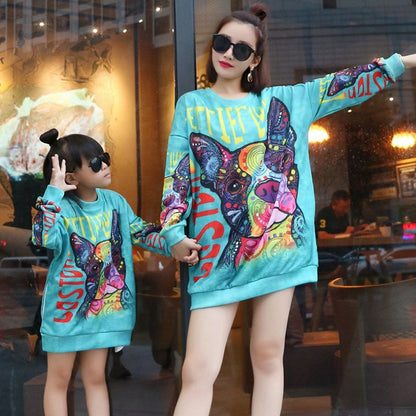 Happy mom and child modelling their cute long-sleeve dog print matching dresses, great for everyday wear.