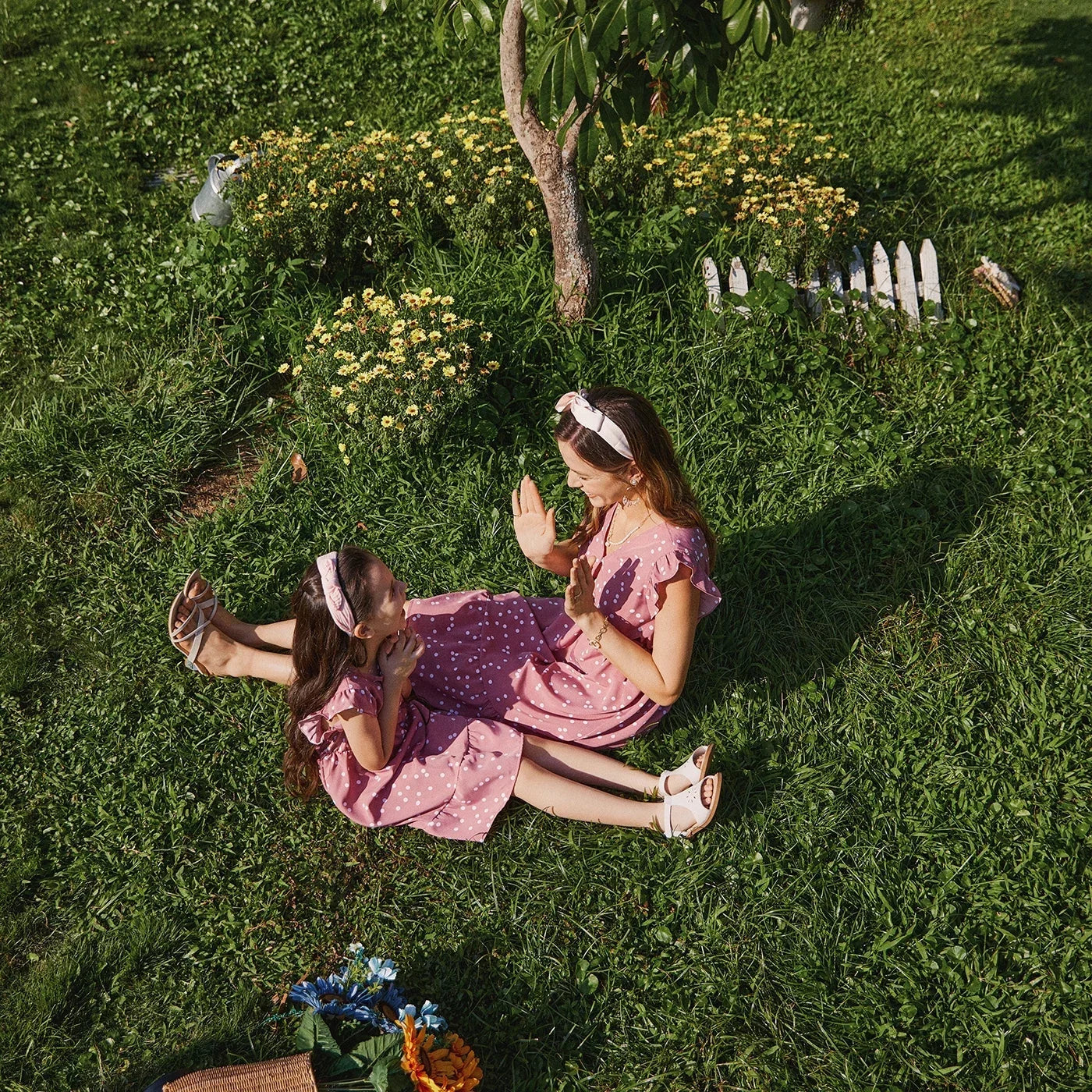 Detailed view of the cross wrap bodice on a pink dotted dress, a flattering design element
