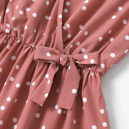 Women's pink dotted summer dress, featuring a flattering V-neck and cross wrap design