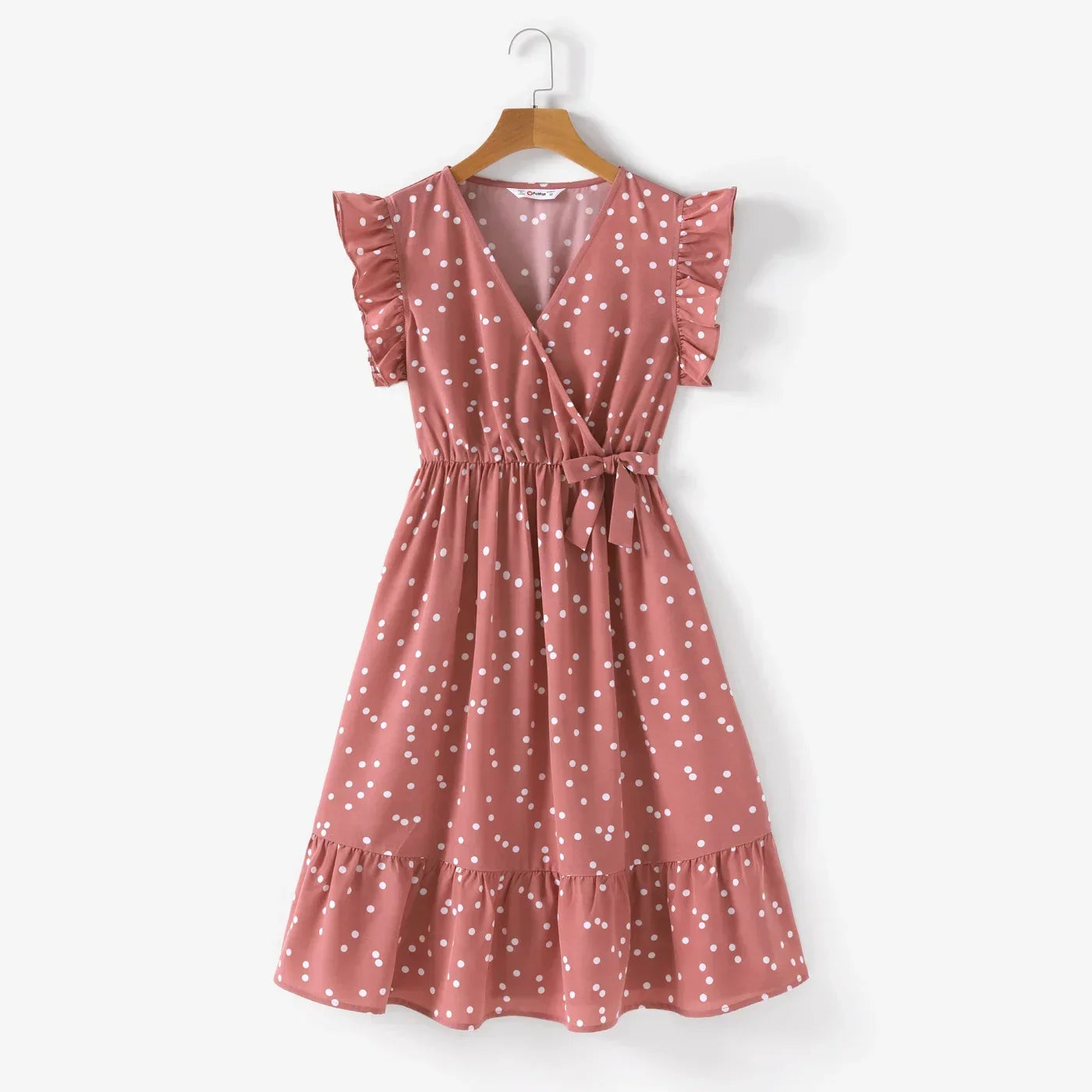 Close-up of pink dotted fabric on a cross wrap dress, highlighting the pattern and texture