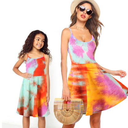 Matching mother daughter sunflower off-shoulder dresses laid flat, showcasing floral print.