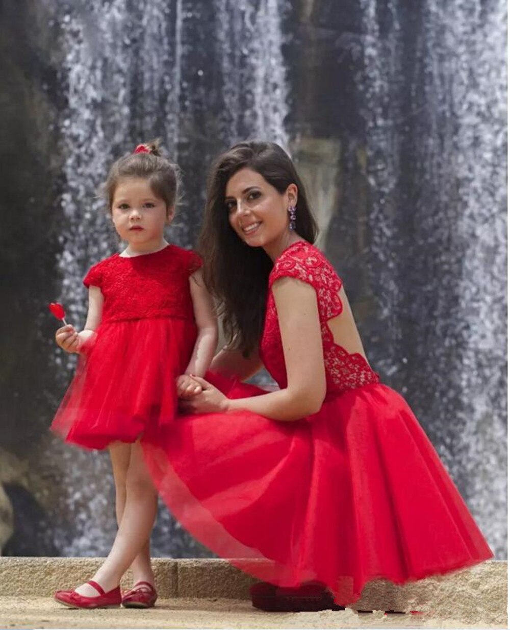 Elegant women's and girl's red lace top cocktail dresses with flowing tulle skirts for family photos