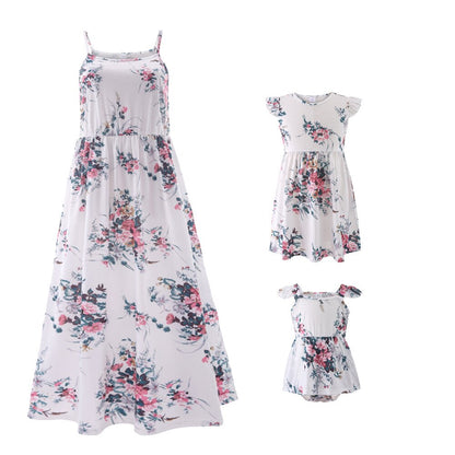 Closeup of a baby girl's floral print dress, part of a family matching outfit set.