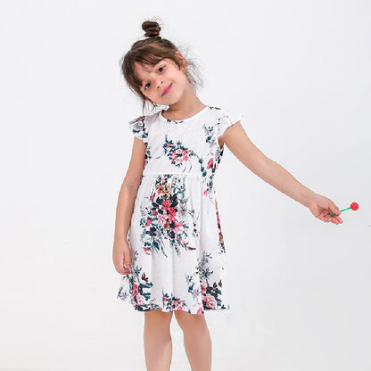 Two generations: mom and daughter wearing cute matching floral print dresses for family photos.