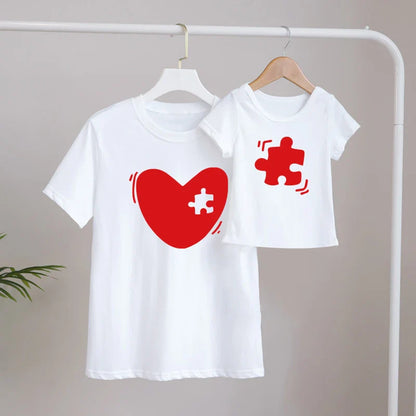 Mom and daughter laughing while wearing matching family print t-shirts, summer casual