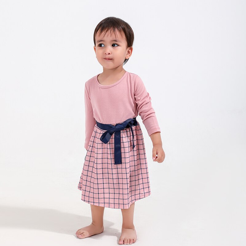 Toddler girl smiling in a cheerful yellow floral cotton dress, perfect for summer family matching