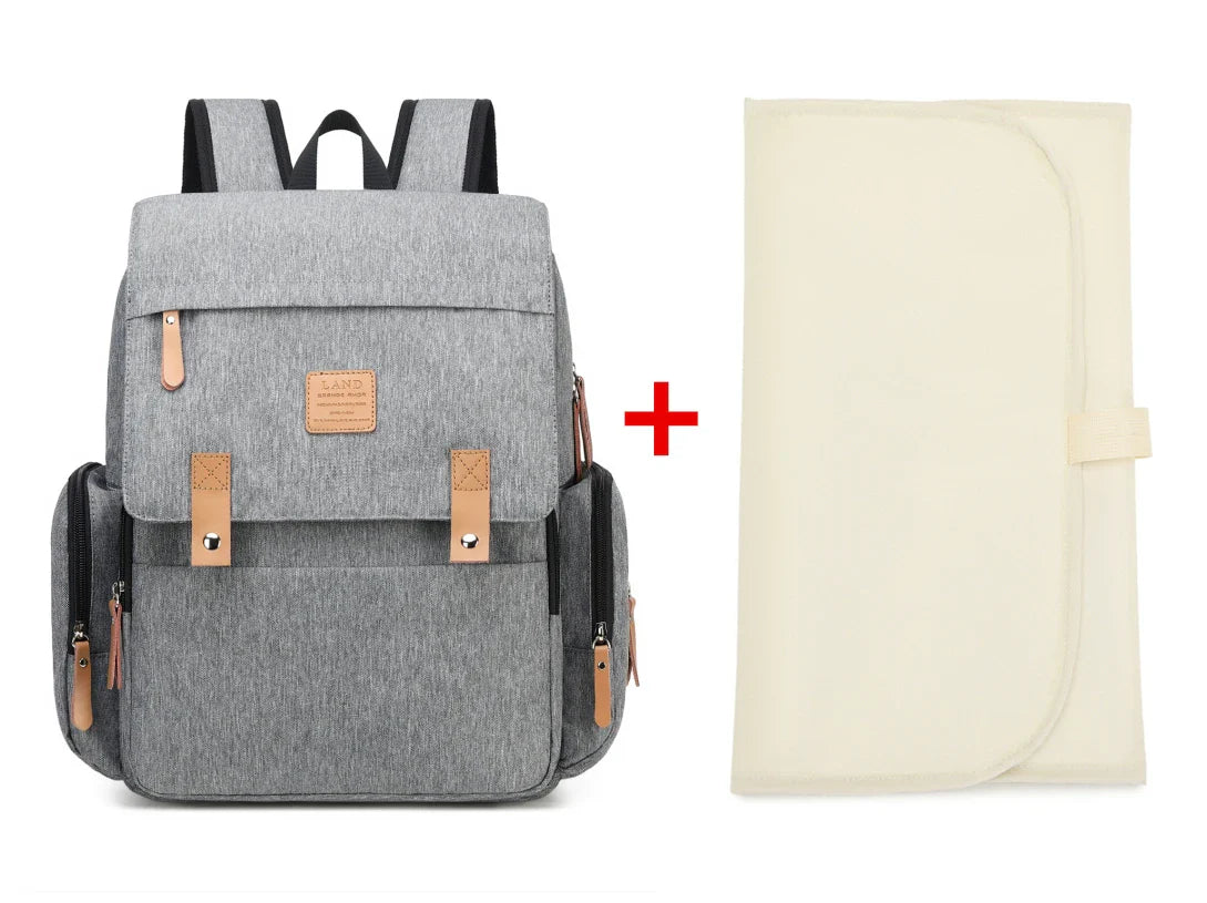 Spacious mommy backpack with integrated changing mat and stroller bag clips