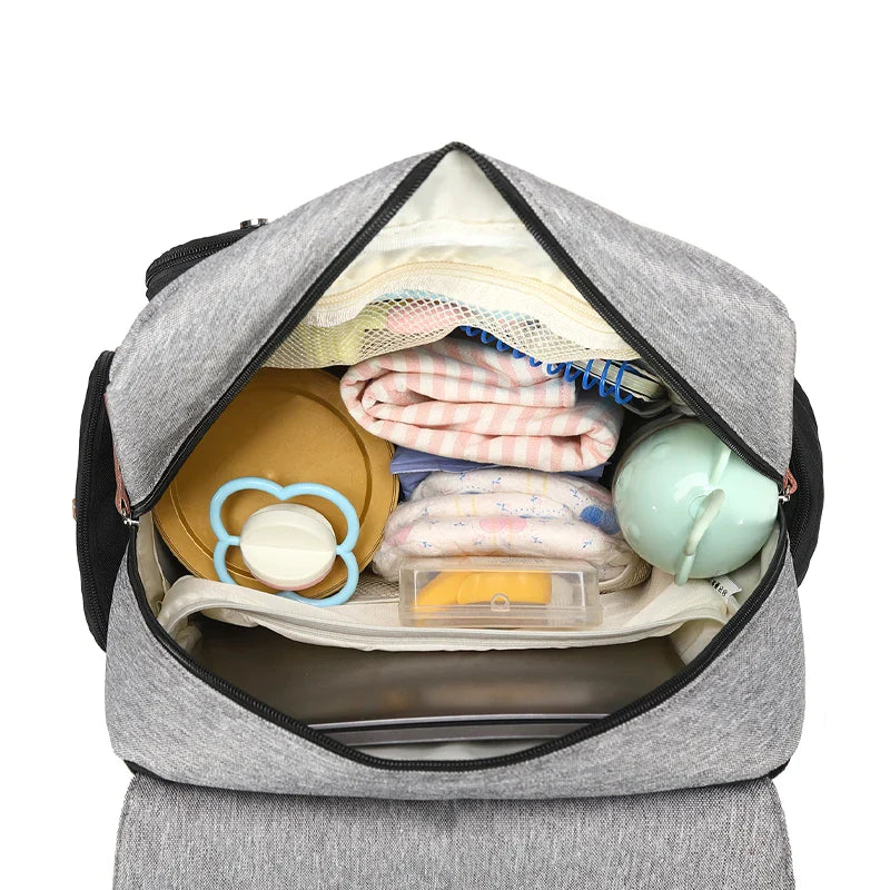 Waterproof diaper backpack for baby travel, featuring a convenient changing mat