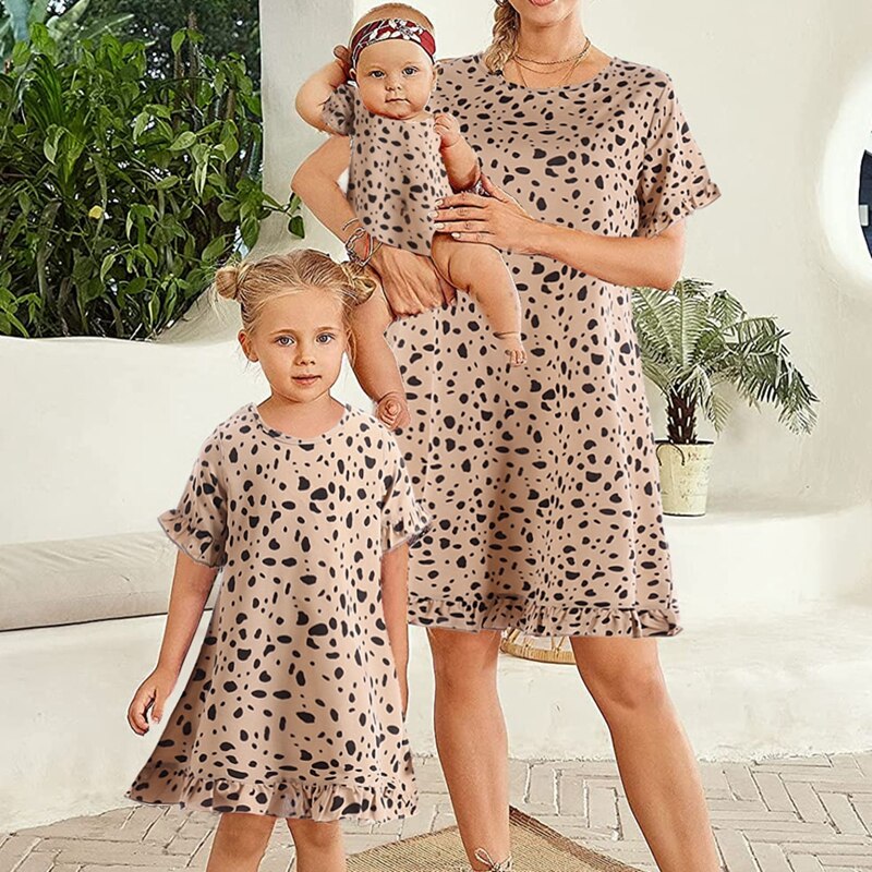 Two leopard print princess dresses, one for women and one for girls, matching family clothing.