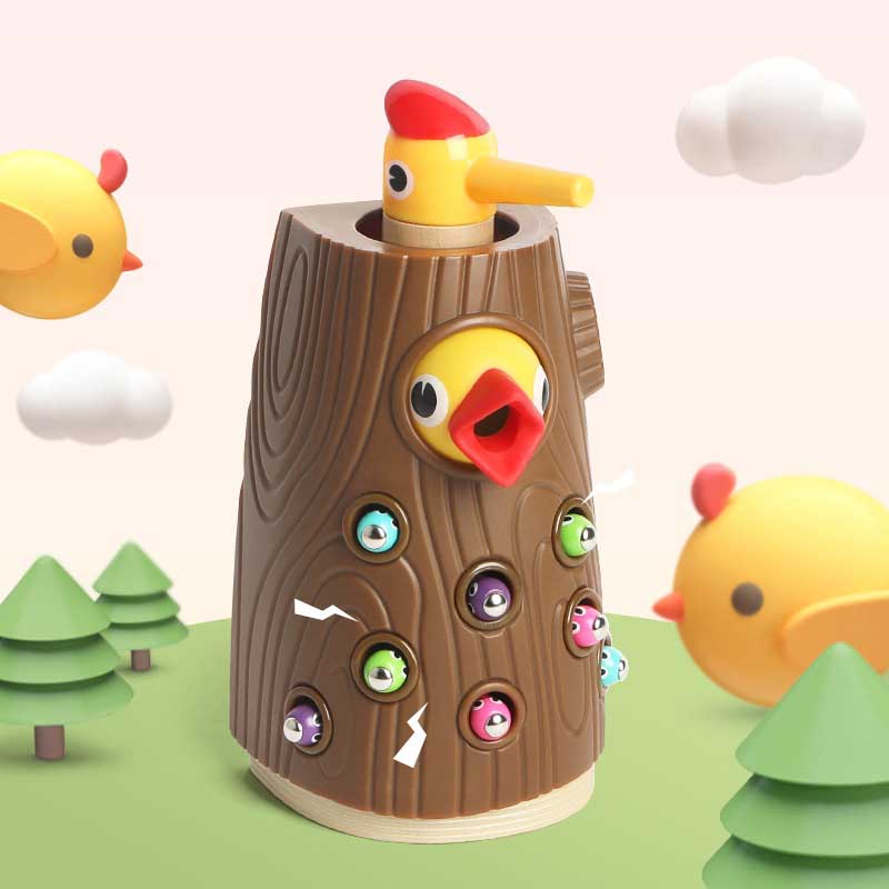 Educational preschool toy: Montessori Hungry Woodpecker. Child feeding plastic worms into tree trunk with magnetic bird