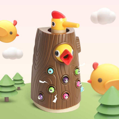 Educational preschool toy: Montessori Hungry Woodpecker. Child feeding plastic worms into tree trunk with magnetic bird