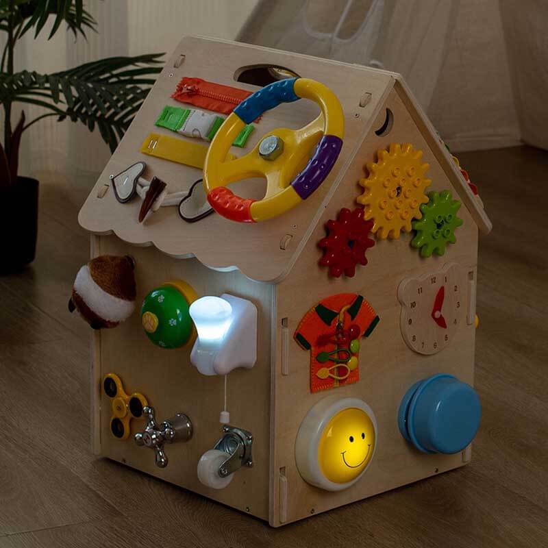 Montessori wooden busy board house toy, designed to stimulate sensory and fine motor development.