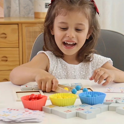Close-up of a Montessori counting educational game, showing hands sorting colorful rings onto numbered pegs.