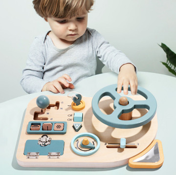 Toddler playing with wooden Montessori steering wheel, an educational pretend play toy for preschoolers