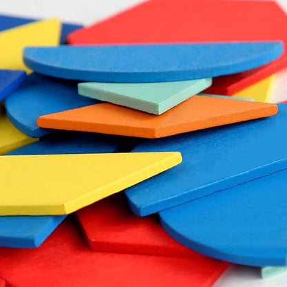 Unisex kids playing with a wooden Montessori tangram puzzle, learning shapes and colors with building blocks