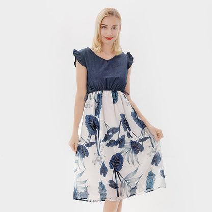 Family matching floral dresses: mother holding daughter, both in cute ruffle sleeve outfits, 'mom daughter dress'